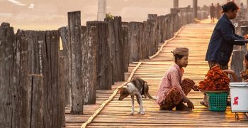 MANDALAY, MYANMAR - APRIL 7, 2012 : Morning life at Ubein Bridge (the longest wooden bridge in the world), Mandalay, Myanmar