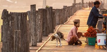 MANDALAY, MYANMAR - APRIL 7, 2012 : Morning life at Ubein Bridge (the longest wooden bridge in the world), Mandalay, Myanmar